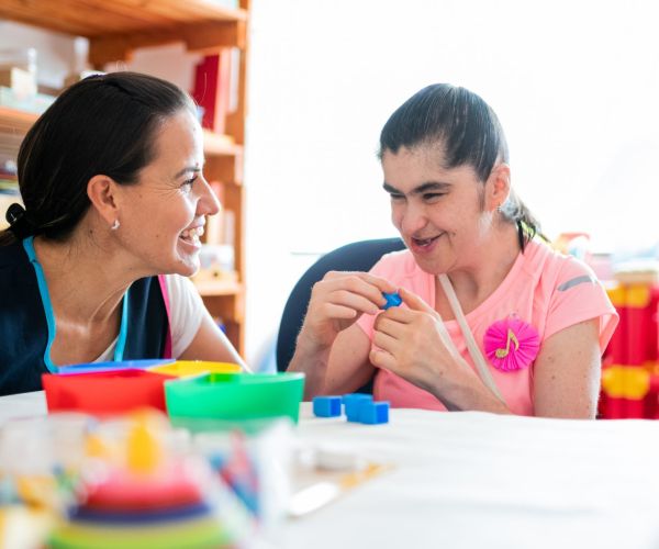 A woman and child play with blocks together