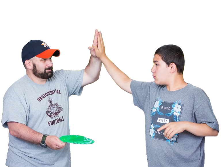 Man and boy high-fiving each other