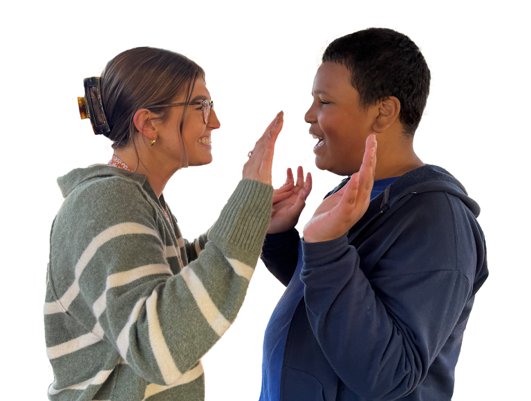 Adult woman and boy smiling while double high-fiving
